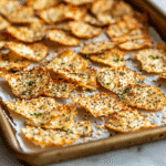 How to Make Baked Cottage Cheese Crisps with Everything Bagel Seasoning – High-Protein & Delicious! 28 baked cottage cheese crisps with everything bagel seasoning on baking tray